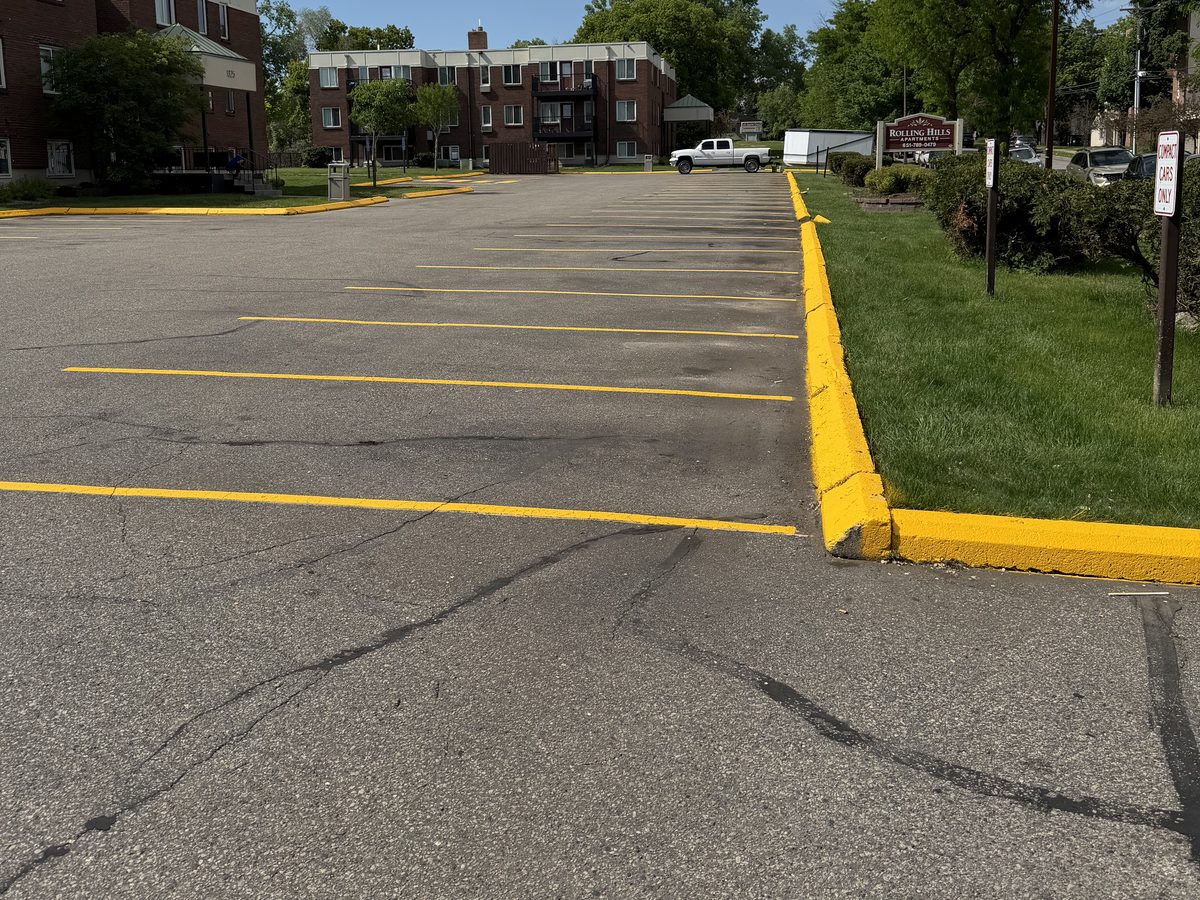 Yellow curb, parking stalls and fire lane restriped at Rolling Hills Apartments